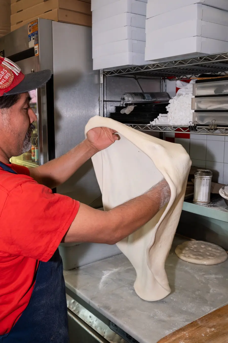 Stretching pizza dough by hand